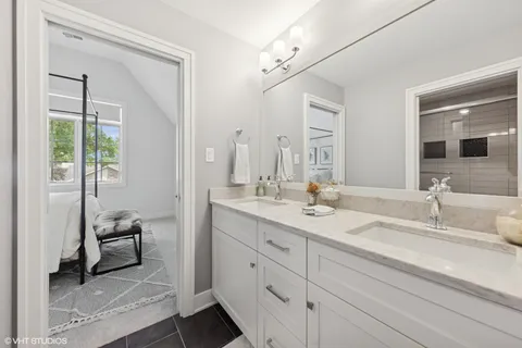 a en suite bathroom with double sink and a mirror