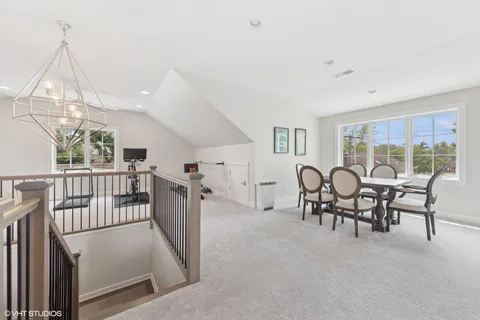 a view of a livingroom with furniture wooden floor and windows