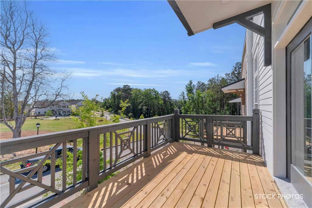 1038 Homestead Way Street Dacula, GA 30019 - Photo 25 of 36 a view of a balcony with wooden floor and fence