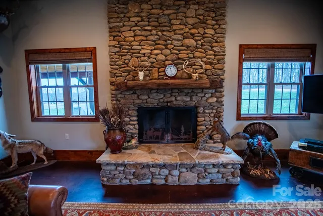 a bedroom with a bed a fireplace and wooden floor