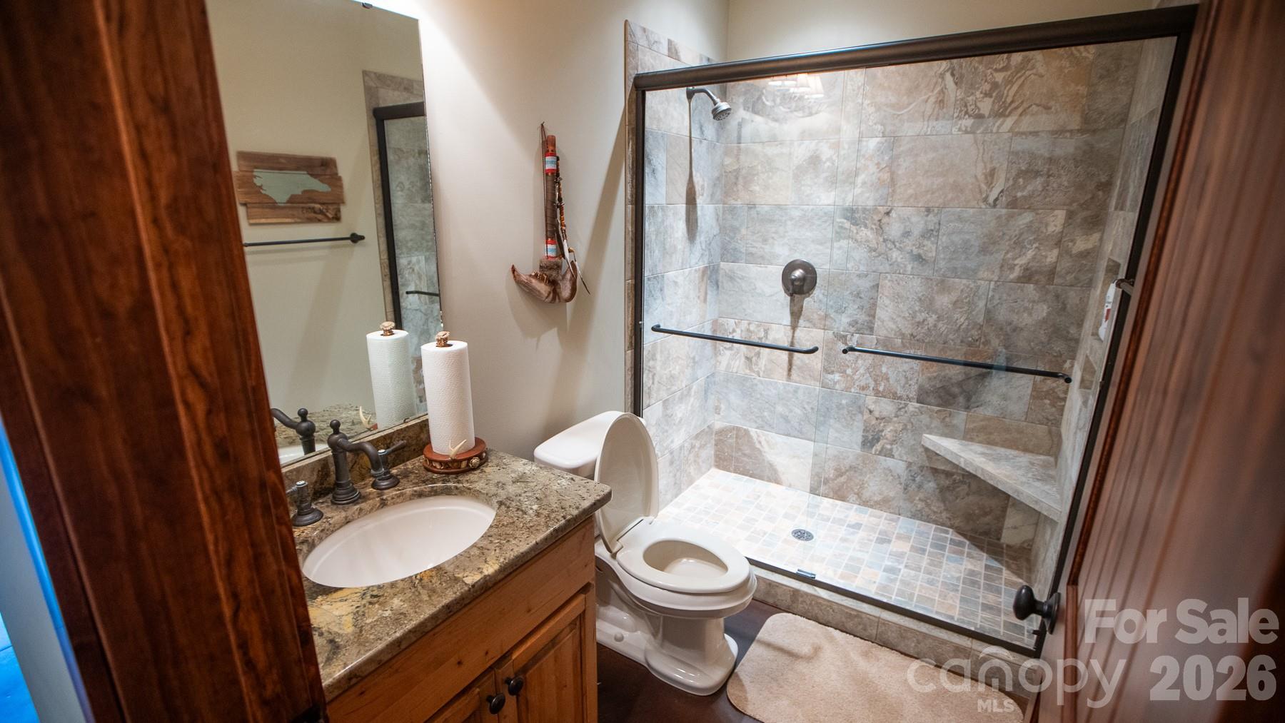 530 Upright Road Mount Ulla, NC 28125 - Photo 9 of 48 a bathroom with a granite countertop sink toilet a mirror and shower