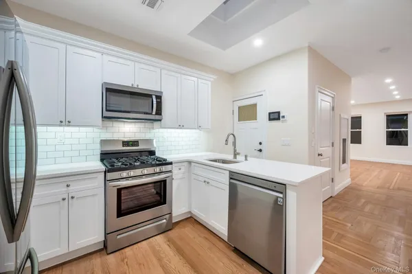 a kitchen with a sink stove and microwave