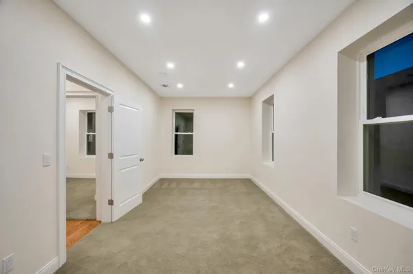a view of hallway with window and stairs