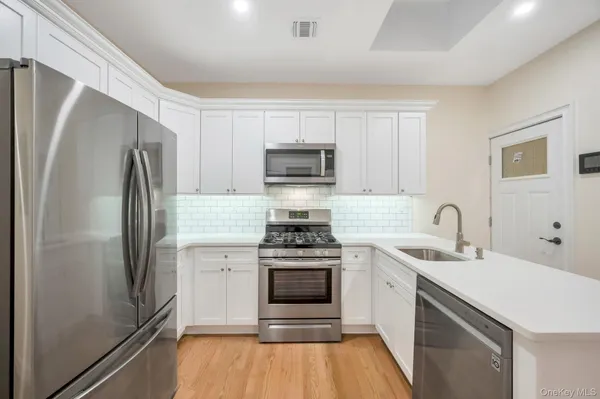 a kitchen with a stove and a refrigerator