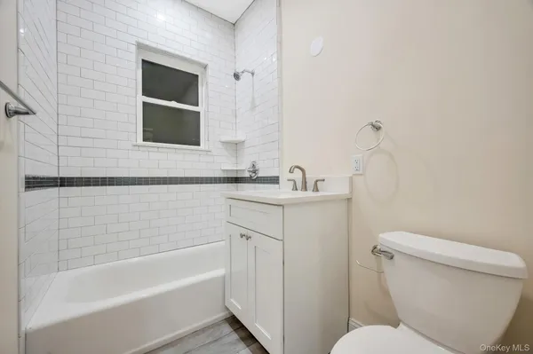 a bathroom with a sink toilet vanity and bathtub