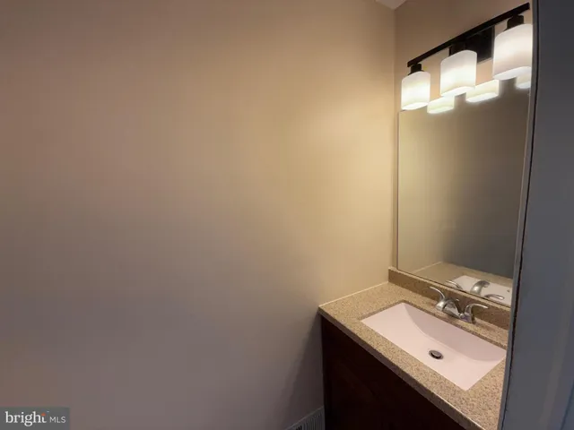 a bathroom with a sink and mirror