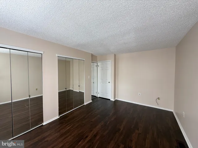 a view of wooden floor and windows in a room