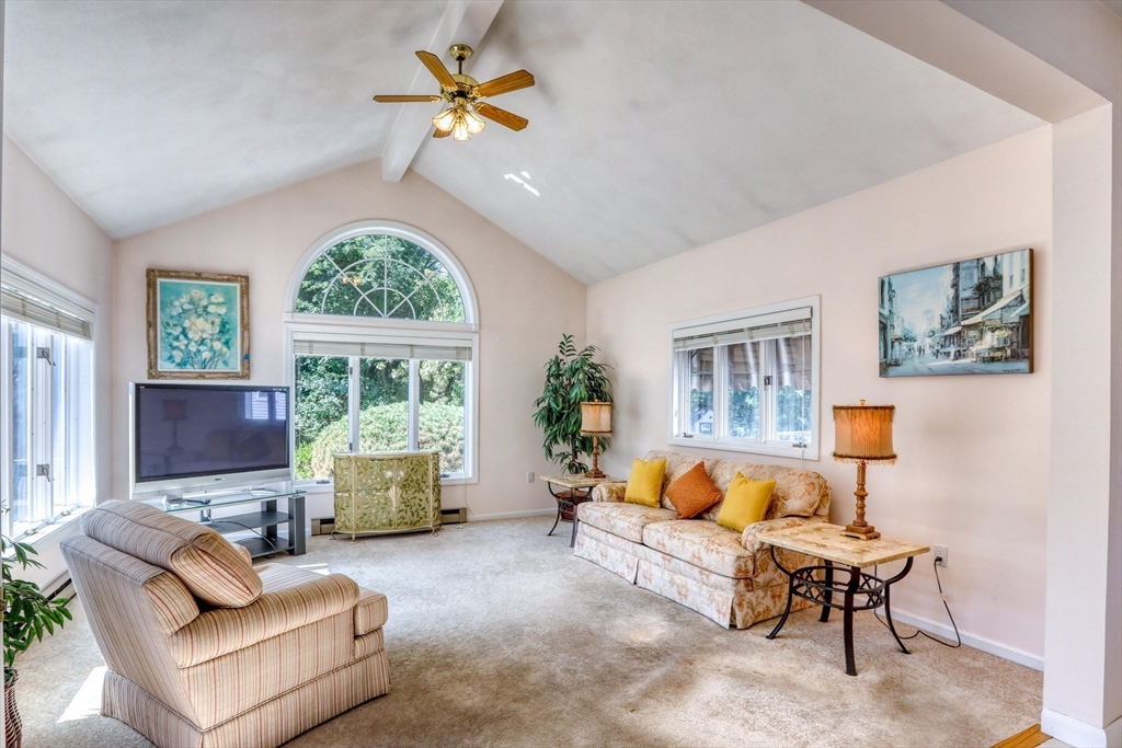 22 Crosby Street Stoneham, MA 02180 - Photo 12 of 30 a living room with furniture a fireplace and a large window