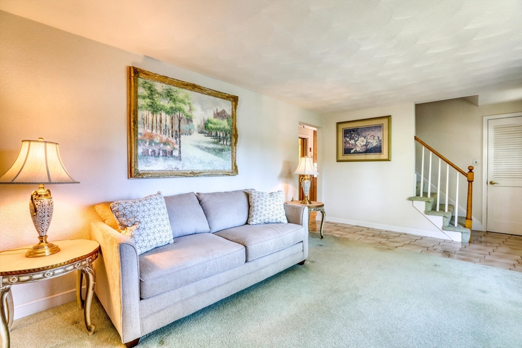 22 Crosby Street Stoneham, MA 02180 - Photo 14 of 30 a living room with furniture and a wall painting
