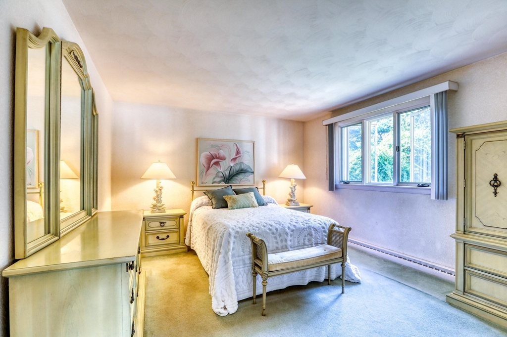 22 Crosby Street Stoneham, MA 02180 - Photo 15 of 30 a bedroom with a bed lamp and a large window with the outer view