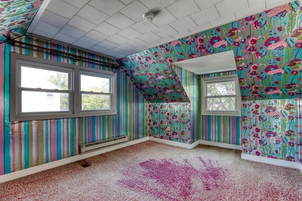 22 Crosby Street Stoneham, MA 02180 - Photo 18 of 30 a living room with furniture and a baby crib