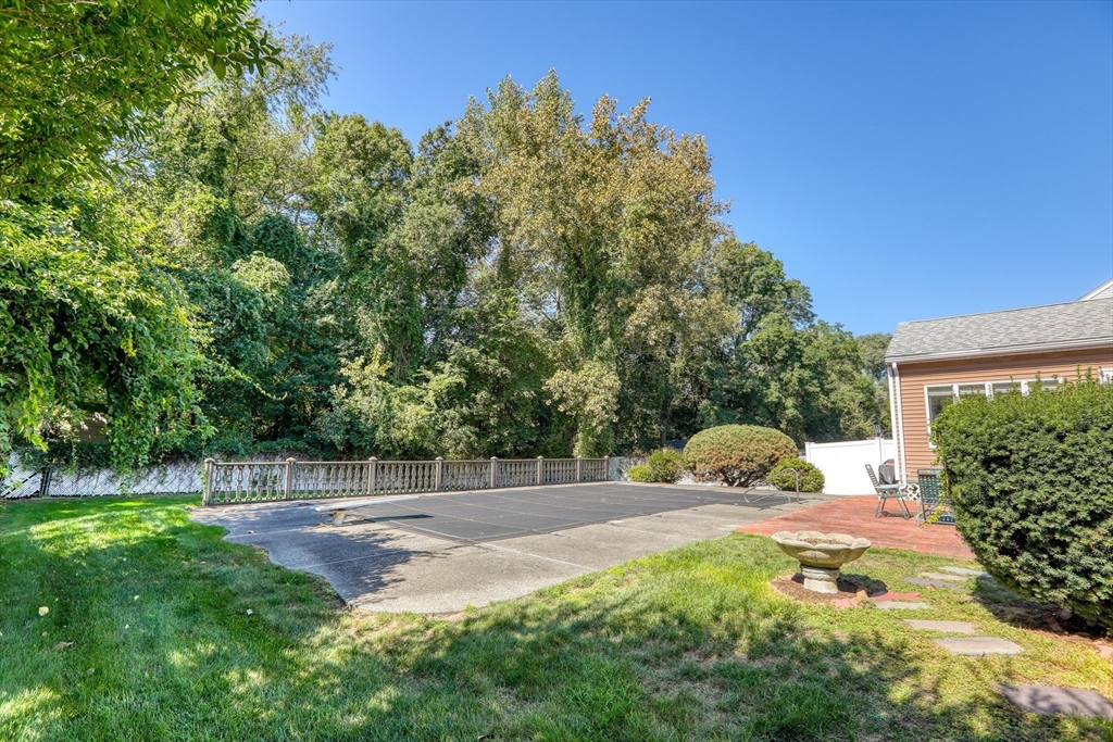 22 Crosby Street Stoneham, MA 02180 - Photo 26 of 30 a view of a yard with a house in the background