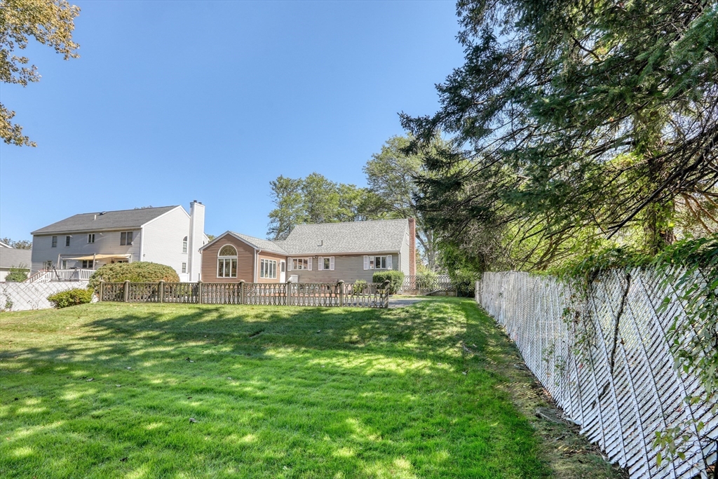 22 Crosby Street Stoneham, MA 02180 - Photo 27 of 30 a view of a house with a big yard and large trees