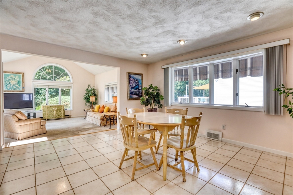 22 Crosby Street Stoneham, MA 02180 - Photo 7 of 30 a view of a dining room with furniture large windows and wooden floor