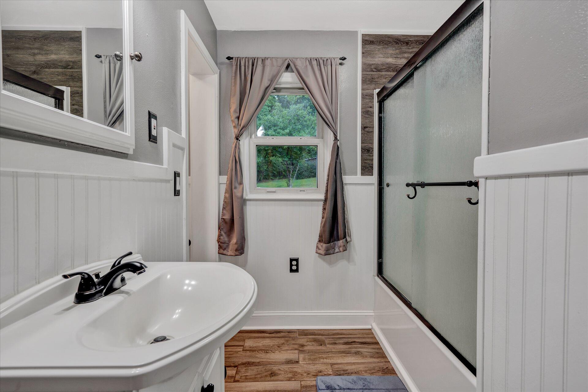 6298 Saunders Road Vinton, VA 24179 - Photo 22 of 31 a bathroom with a sink a window and a shower