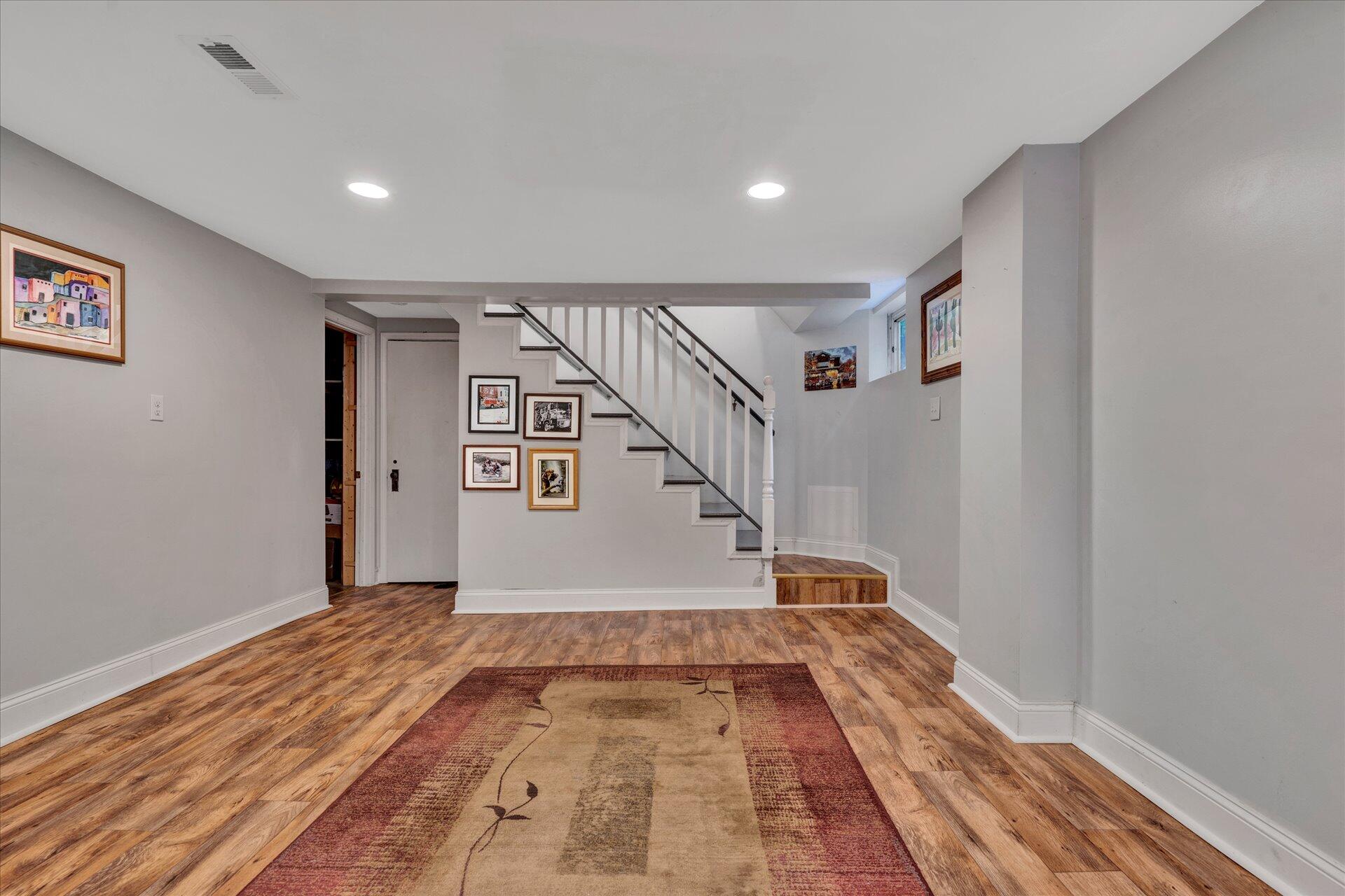 6298 Saunders Road Vinton, VA 24179 - Photo 5 of 31 a view of a hallway with wooden floor and staircase