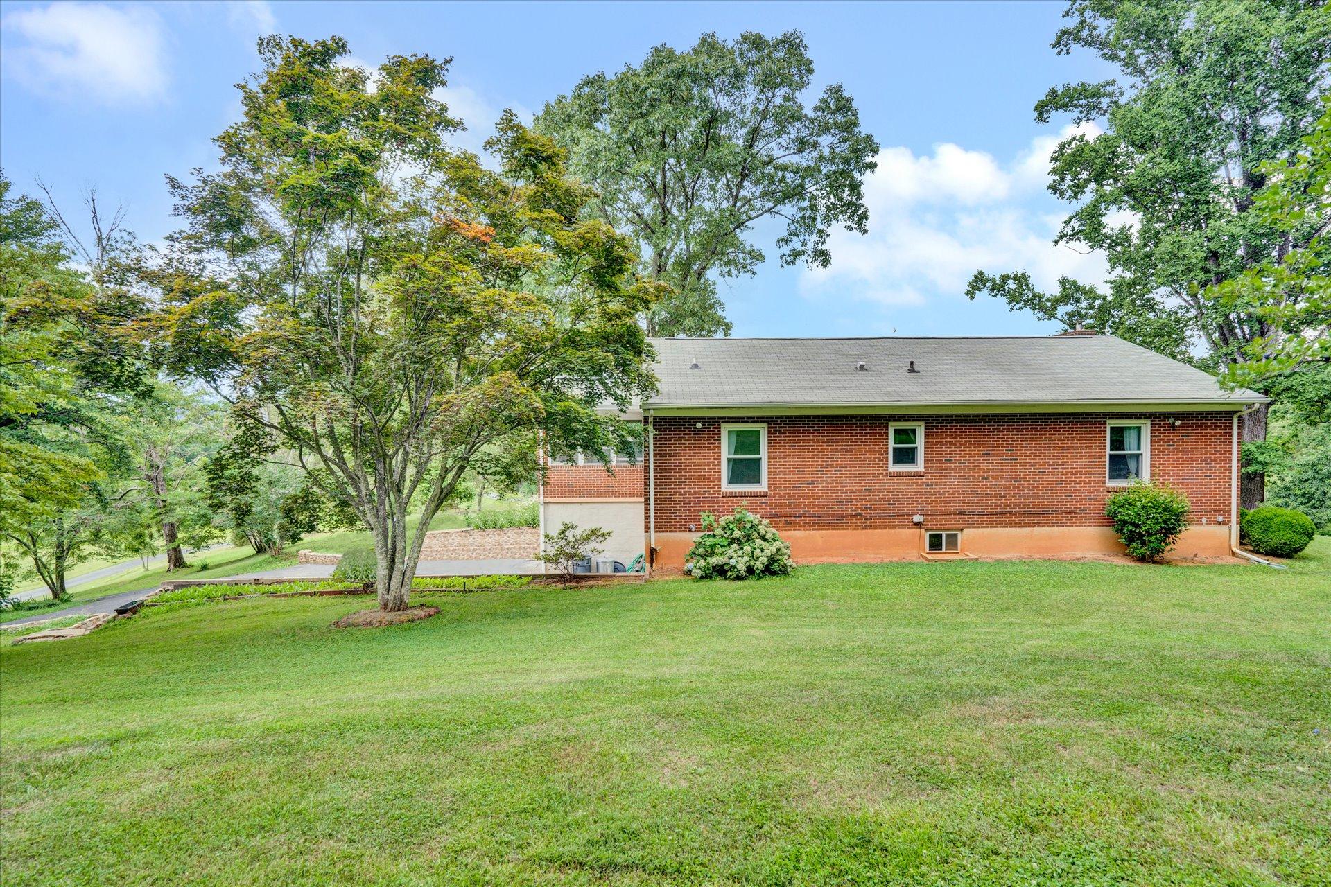 6298 Saunders Road Vinton, VA 24179 - Photo 6 of 31 a brick house with a yard