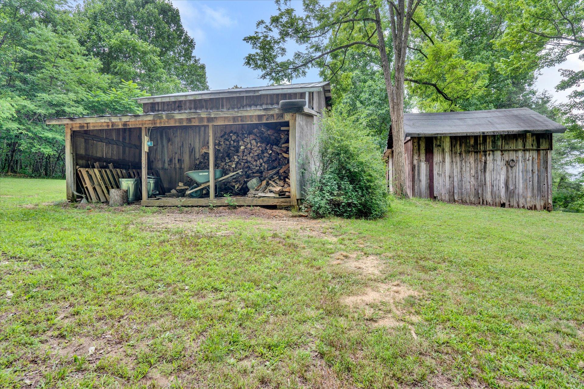 6298 Saunders Road Vinton, VA 24179 - Photo 7 of 31 a view of a backyard with plants and a large tree