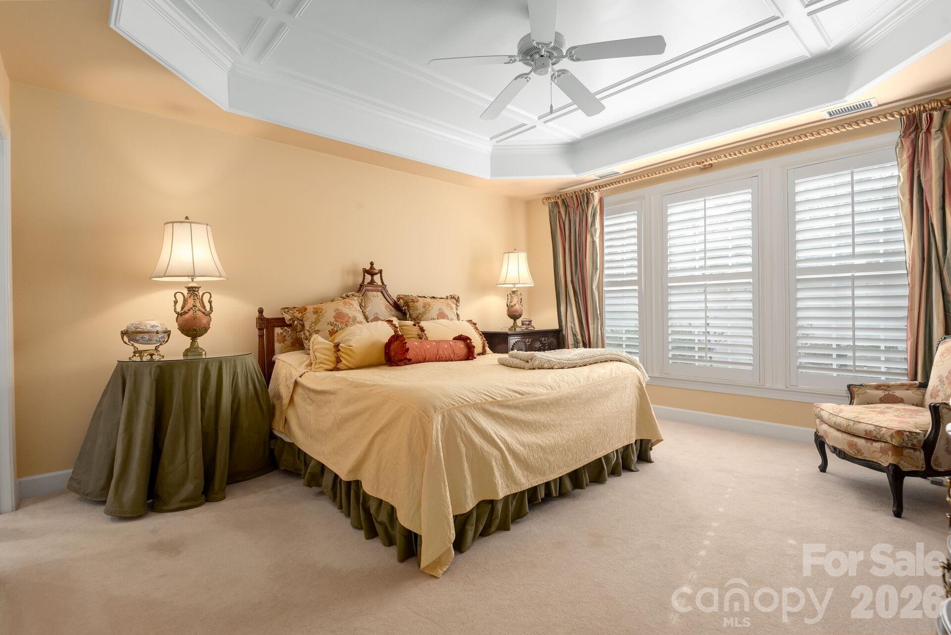 8124 Oratorio Place Charlotte, NC 28270 - Photo 15 of 38 a spacious bedroom with a bed and a chandelier