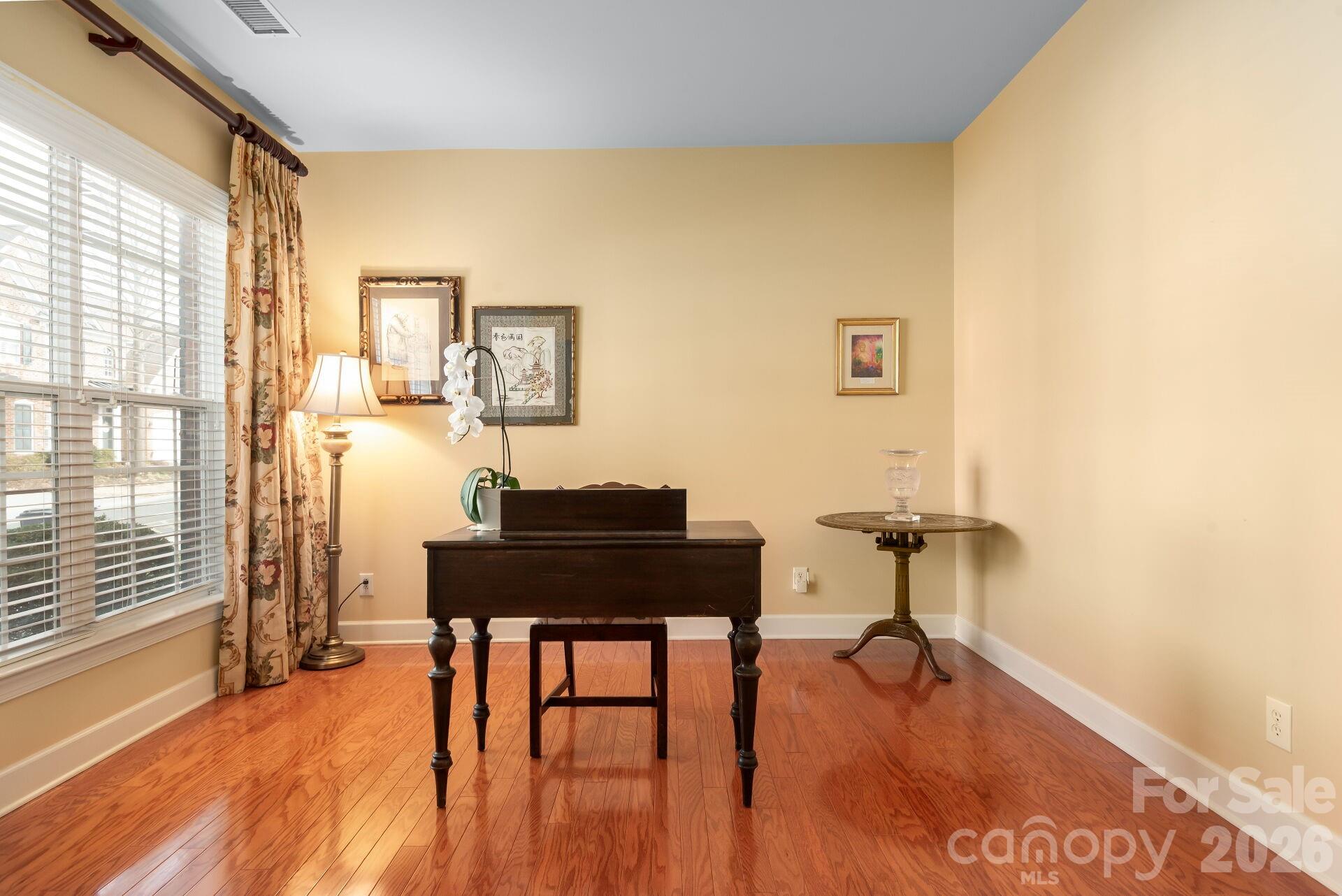 8124 Oratorio Place Charlotte, NC 28270 - Photo 24 of 38 a living room with furniture and a wooden floor