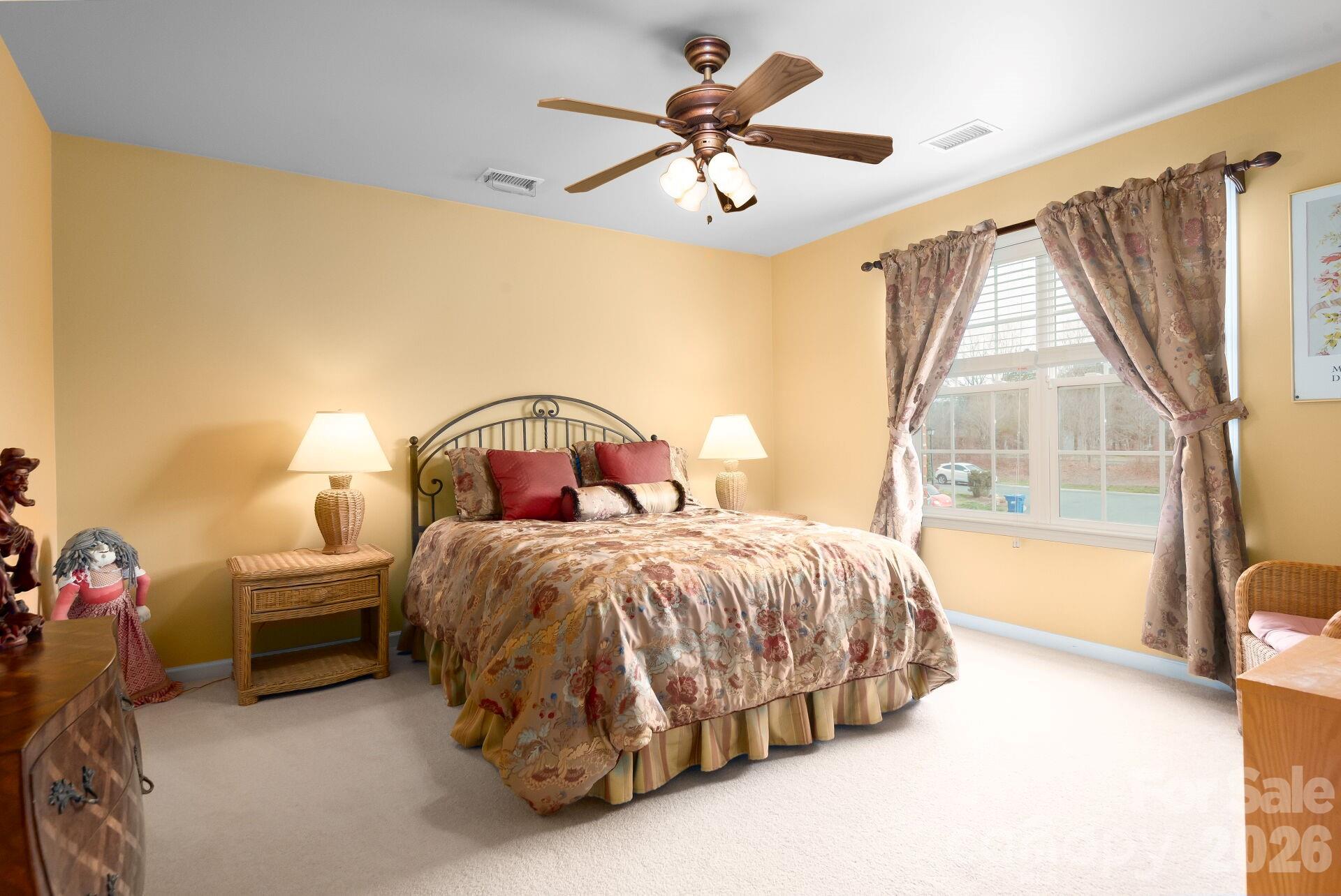 8124 Oratorio Place Charlotte, NC 28270 - Photo 27 of 38 a bedroom with a bed next to a window
