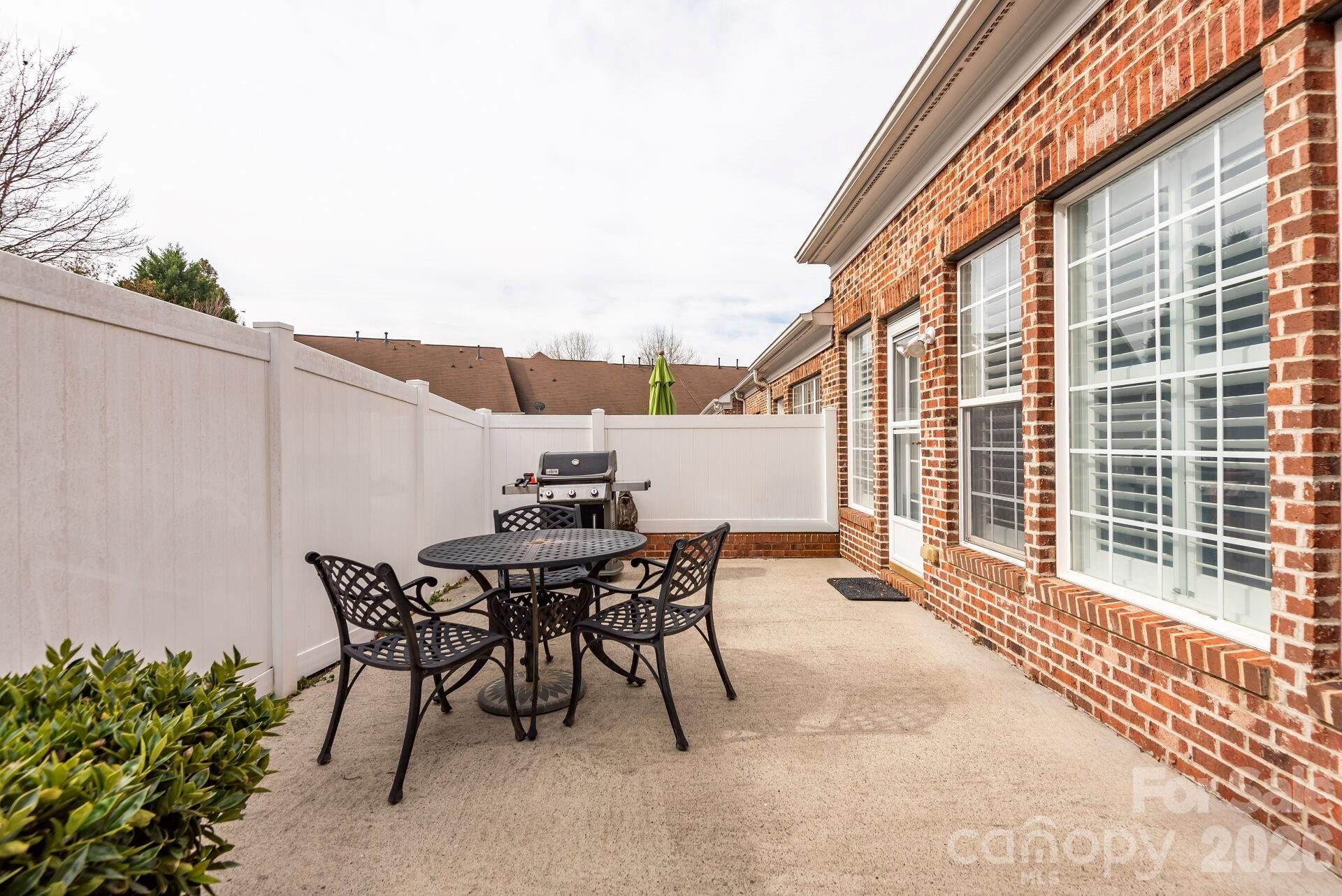 8124 Oratorio Place Charlotte, NC 28270 - Photo 29 of 38 a view of a patio with a table and chairs