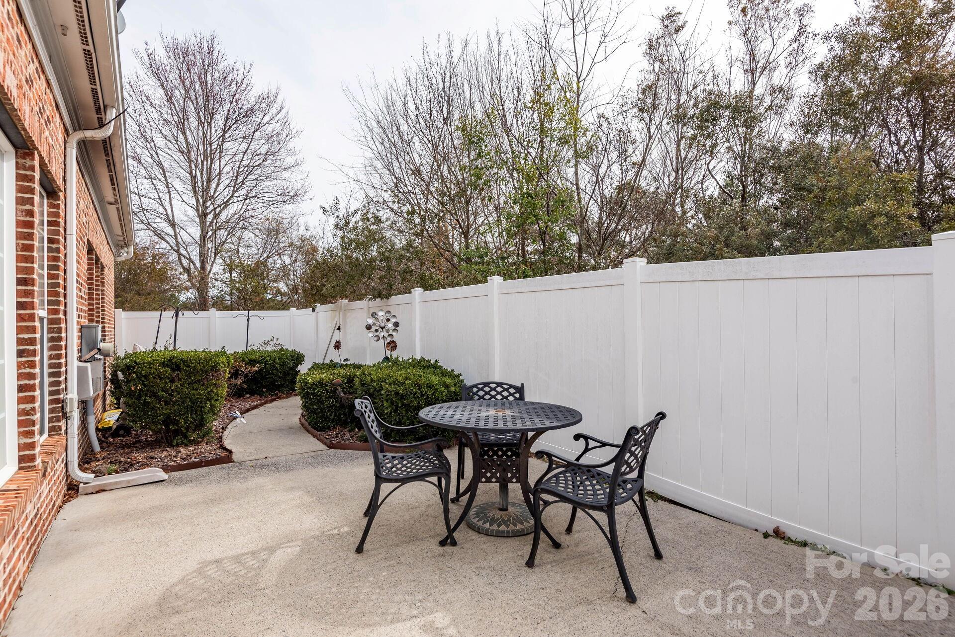 8124 Oratorio Place Charlotte, NC 28270 - Photo 30 of 38 a view of a chairs and tables in the backyard