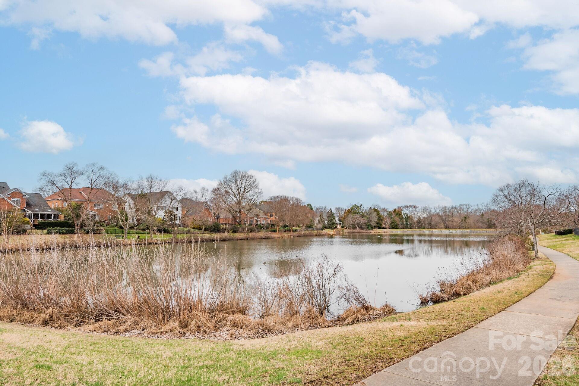 8124 Oratorio Place Charlotte, NC 28270 - Photo 31 of 38 a view of a lake with houses in the back