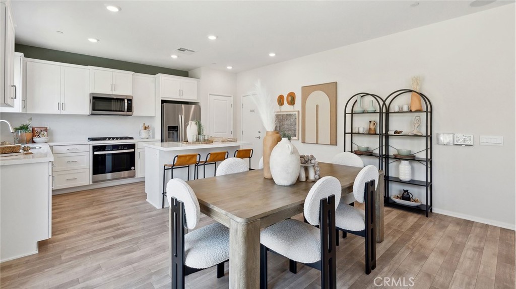 11392 Forge Road Corona, CA 92883 - Photo 5 of 24 a view of a dining room with furniture and wooden floor
