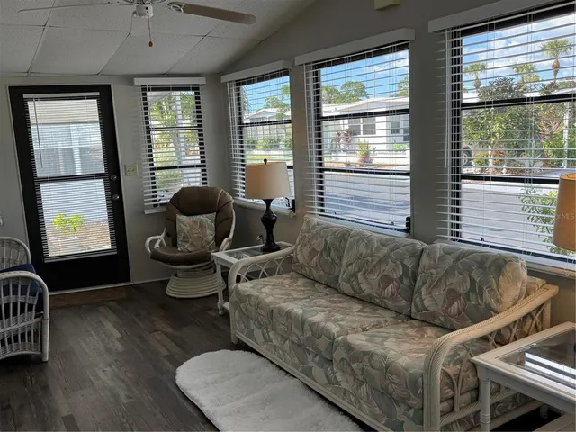 a living room with furniture and large windows