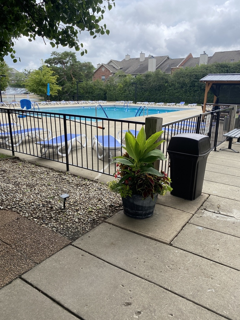 2015 South Finley Road, Unit 1101 Lombard, IL 60148 - Photo 19 of 24 a view of a patio with a table and chairs potted plants