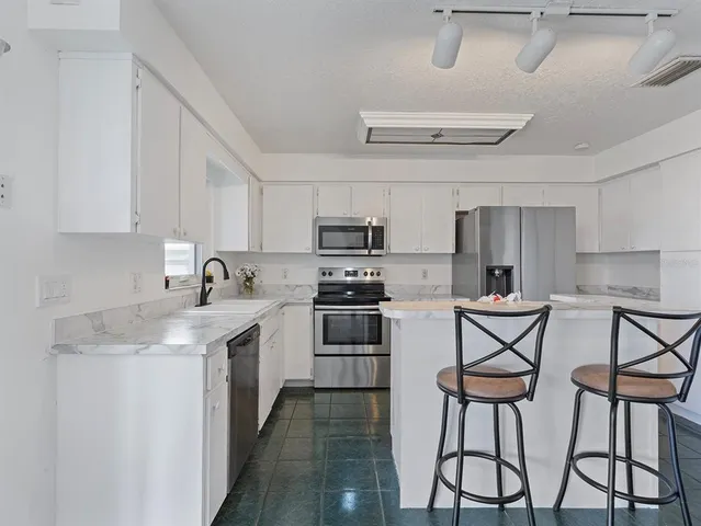 an aerial view of residential houses with outdoor space and swimming pool
