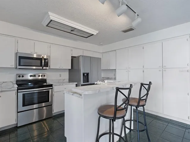 an aerial view of residential house with outdoor space and parking