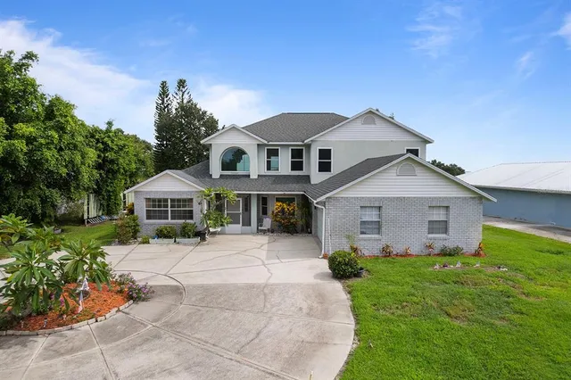 a living room with furniture a rug and a chandelier