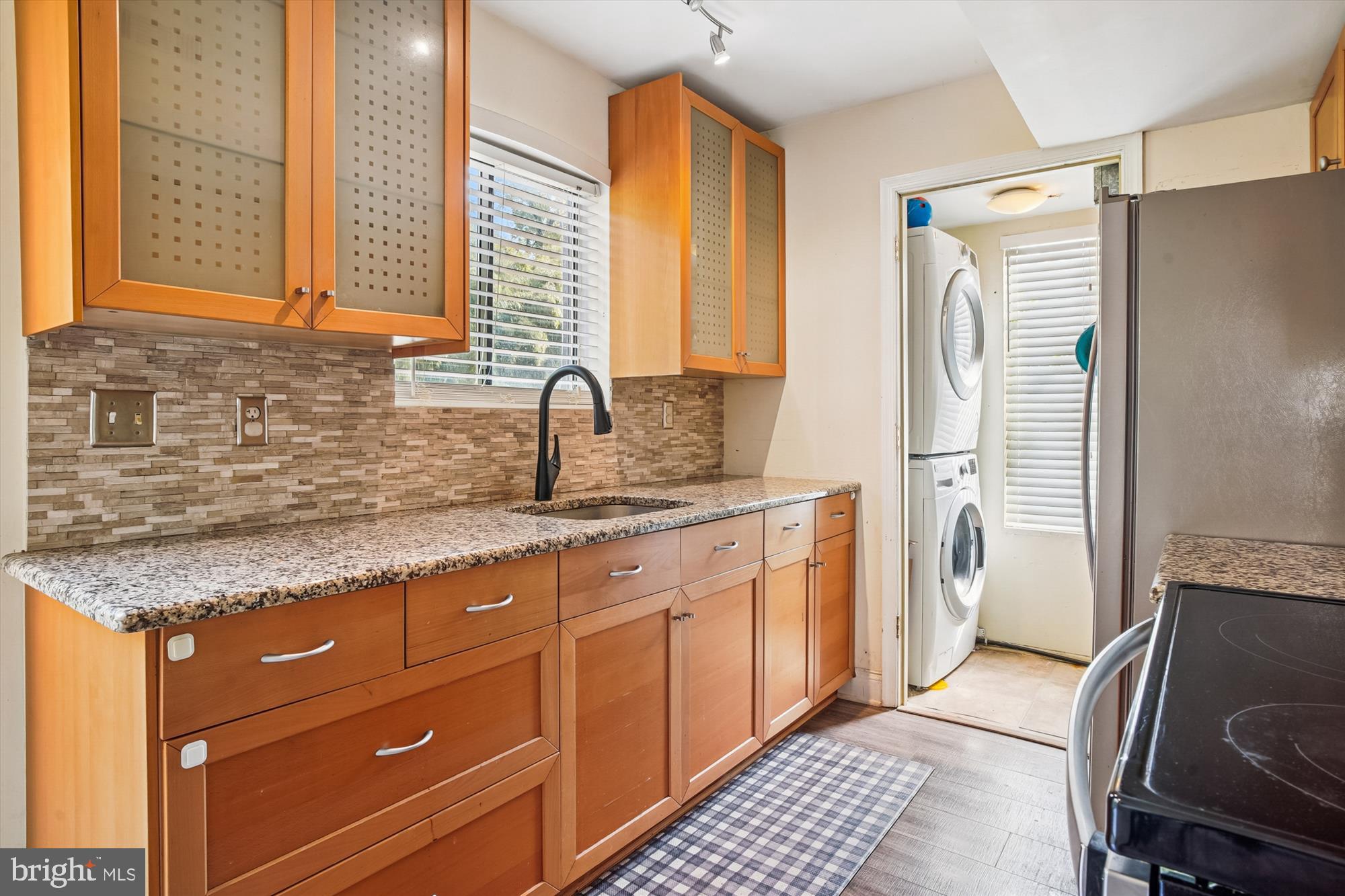 1745 Ridgely Road Edgewater, MD 21037 - Photo 12 of 43 a kitchen with a granite countertop sink and a refrigerator