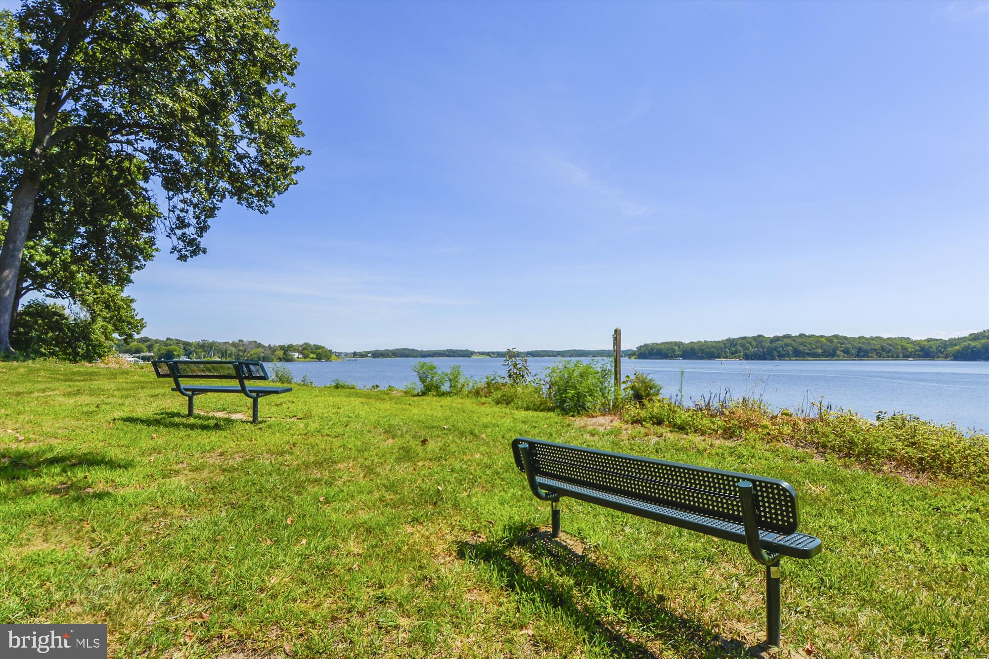 1745 Ridgely Road Edgewater, MD 21037 - Photo 26 of 43 a view of a lake with a bench and lake view