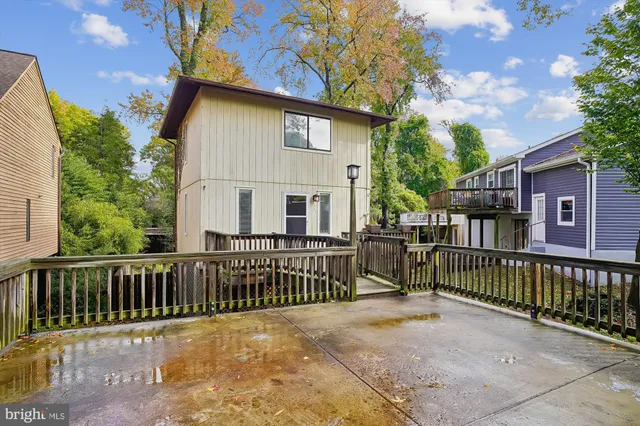 a view of a house with a wooden fence