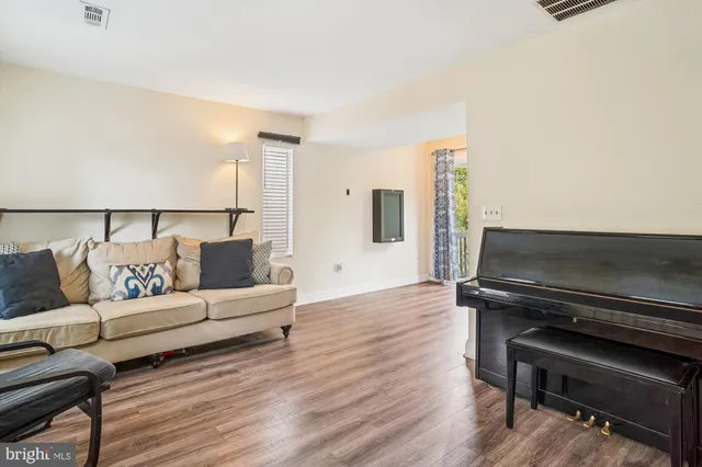 a living room with furniture and a piano