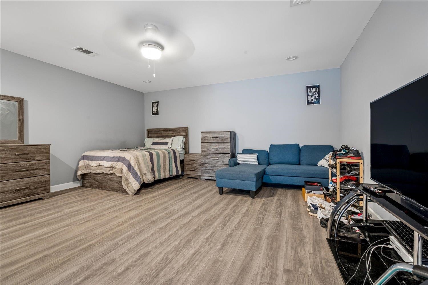 8867 Hampton Court Road East Memphis, TN 38016 - Photo 20 of 23 Spacious interior featuring wood-finish flooring, a ceiling fan, recessed lighting, and light gray wall paint