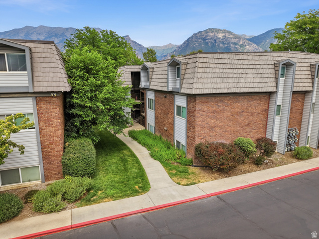 1700 Hickory Lane Provo, UT 84604 - Photo 5 of 20 Multi-story residential buildings featuring brick and siding exteriors, dormer windows, and a shingled roof