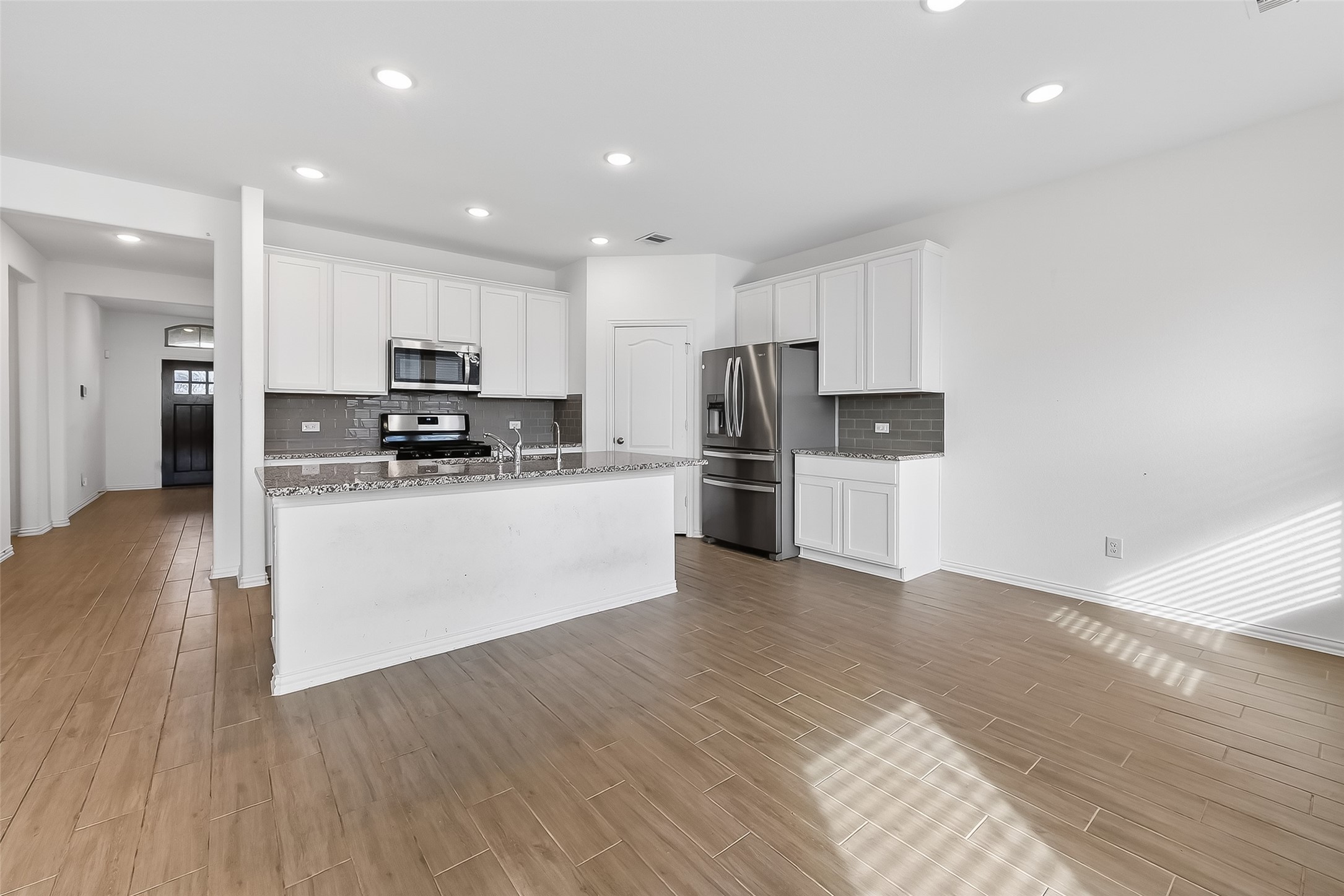 31215 Conover Drive Fulshear, TX 77441 - Photo 17 of 42 a kitchen with stainless steel appliances a refrigerator sink and microwave
