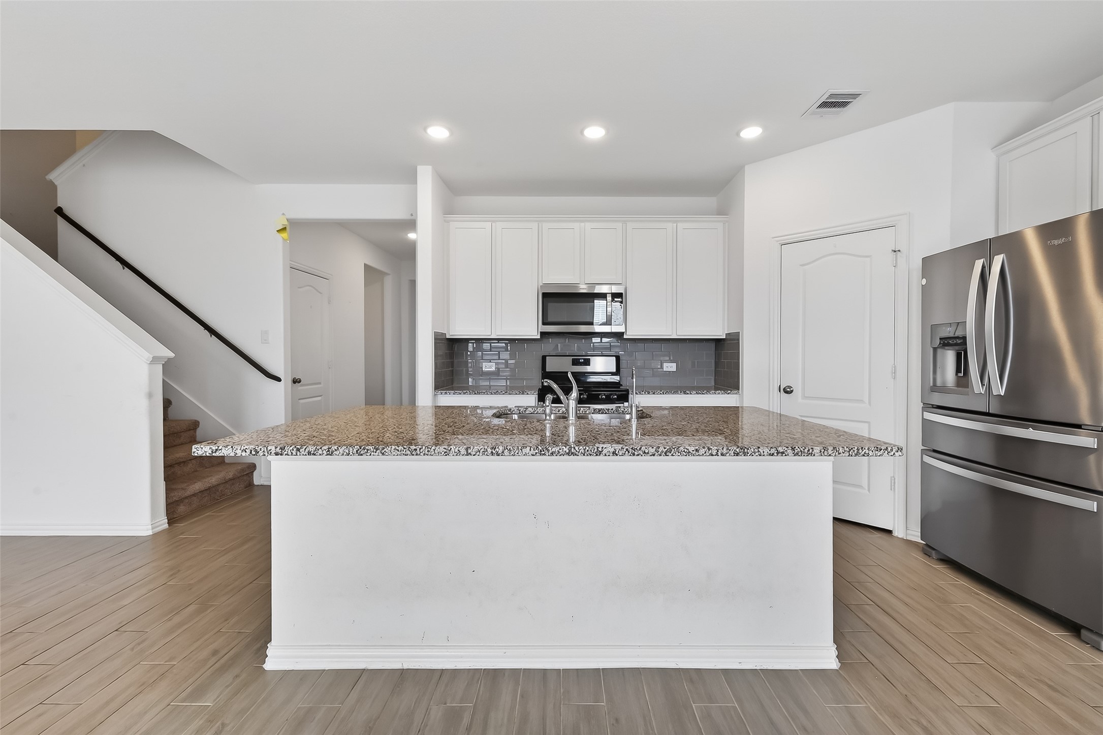31215 Conover Drive Fulshear, TX 77441 - Photo 20 of 42 a view of kitchen with stainless steel appliances granite countertop a refrigerator a stove a sink and a dining table with wooden floor