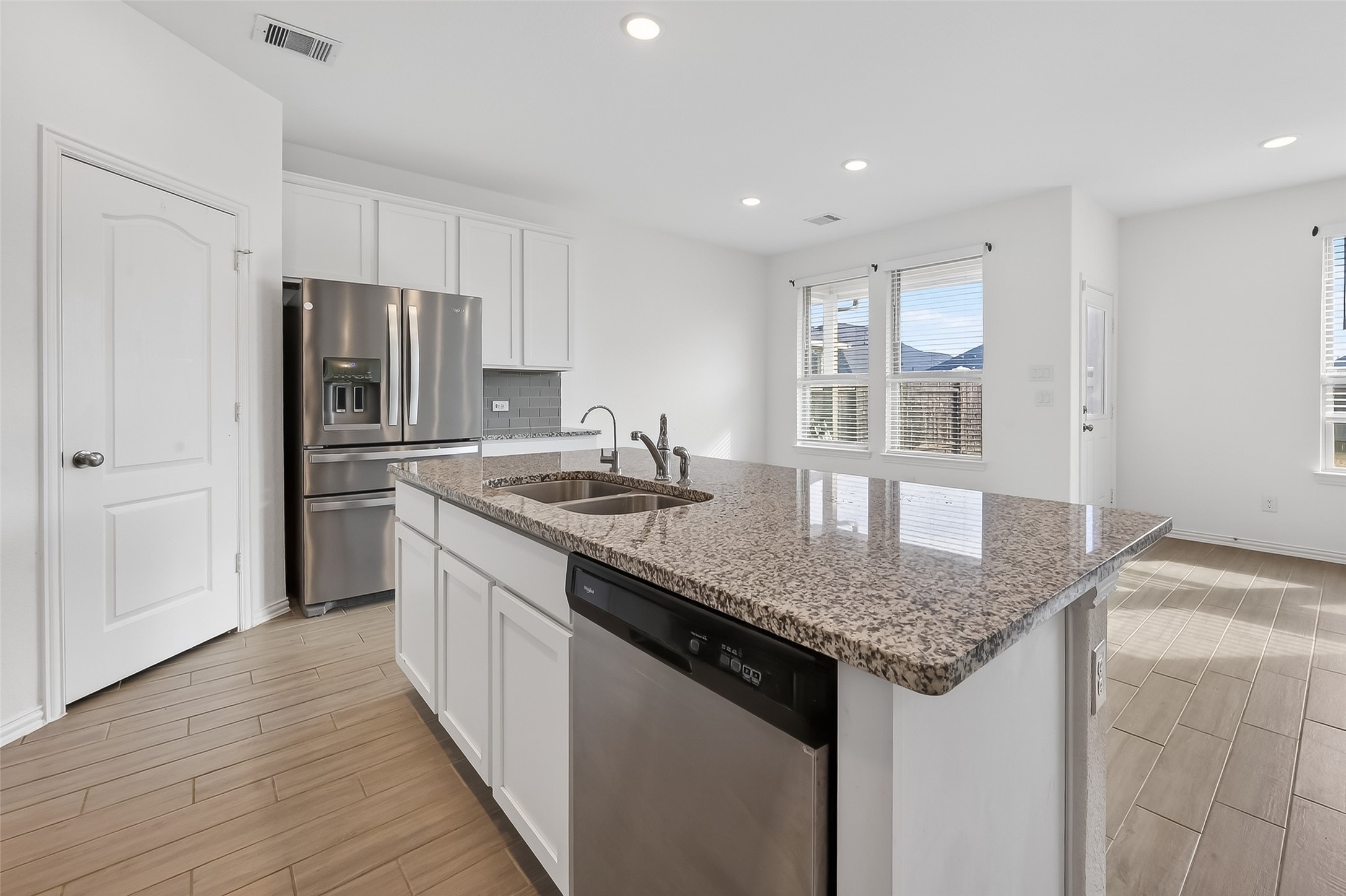 31215 Conover Drive Fulshear, TX 77441 - Photo 23 of 42 a kitchen with stainless steel appliances granite countertop a sink stove and refrigerator