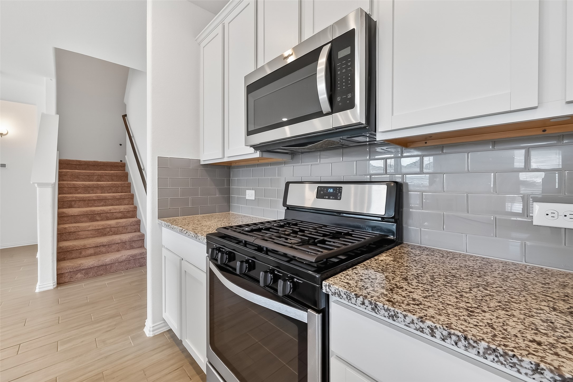 31215 Conover Drive Fulshear, TX 77441 - Photo 25 of 42 a kitchen with stainless steel appliances granite countertop a stove and a microwave