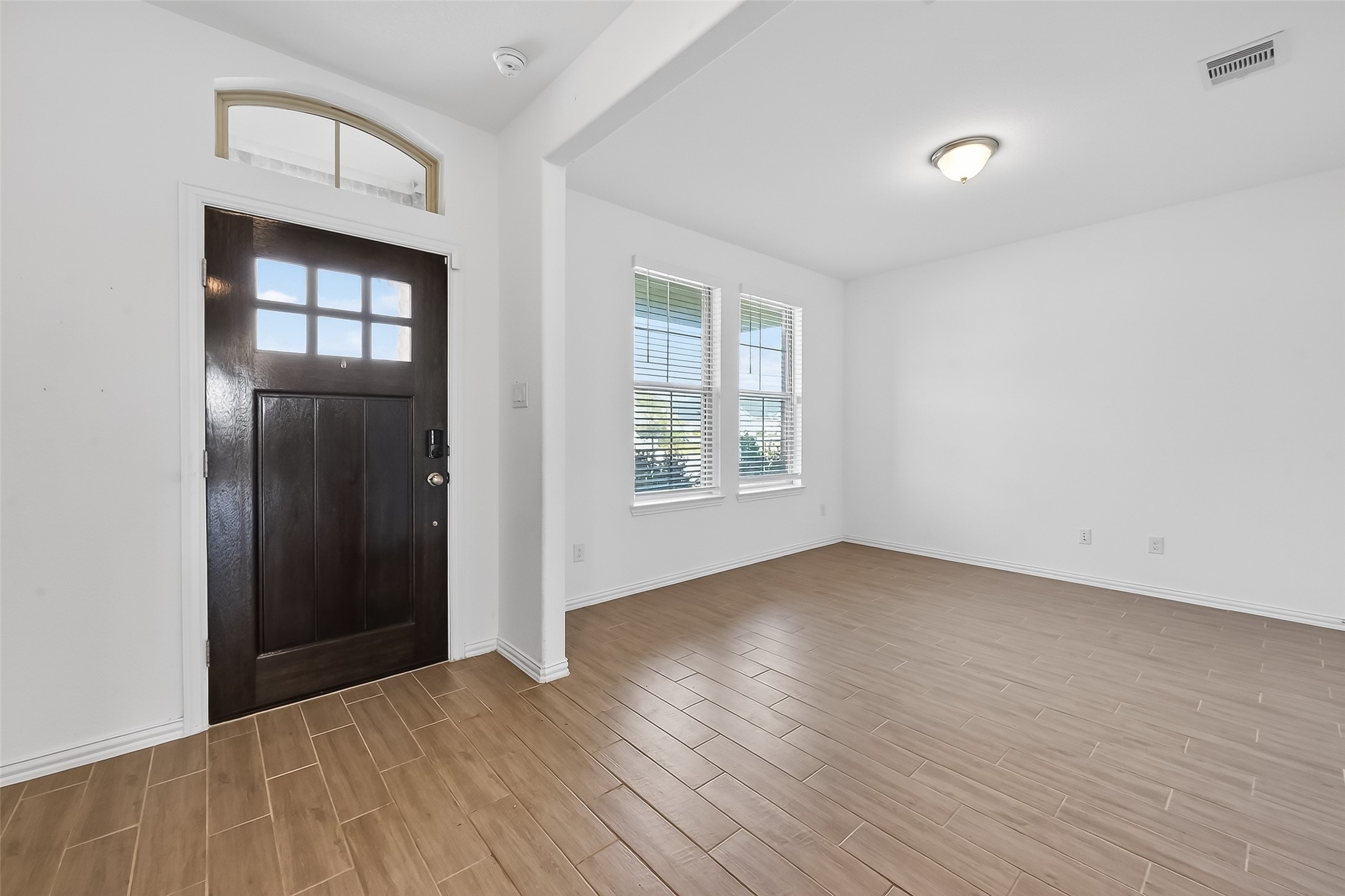 31215 Conover Drive Fulshear, TX 77441 - Photo 6 of 42 an empty room with wooden floor and windows