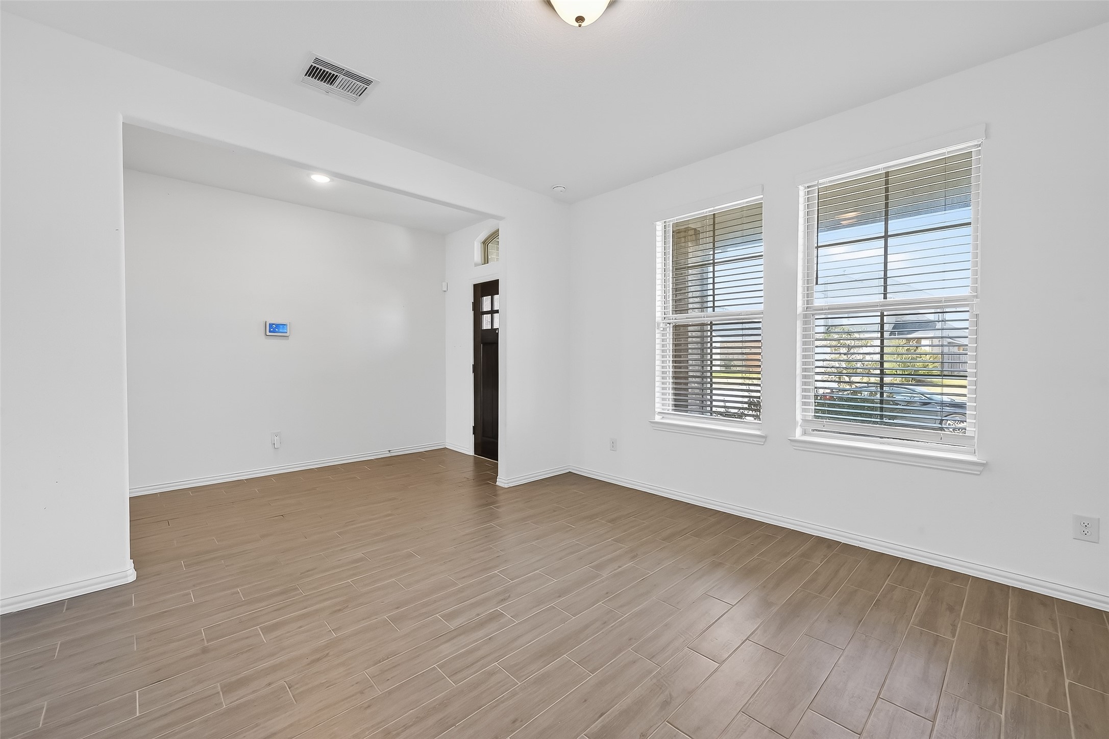 31215 Conover Drive Fulshear, TX 77441 - Photo 9 of 42 a view of an empty room with wooden floor and a window