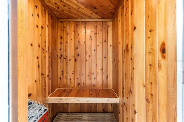 a bedroom with a bed a chandelier fan and a window