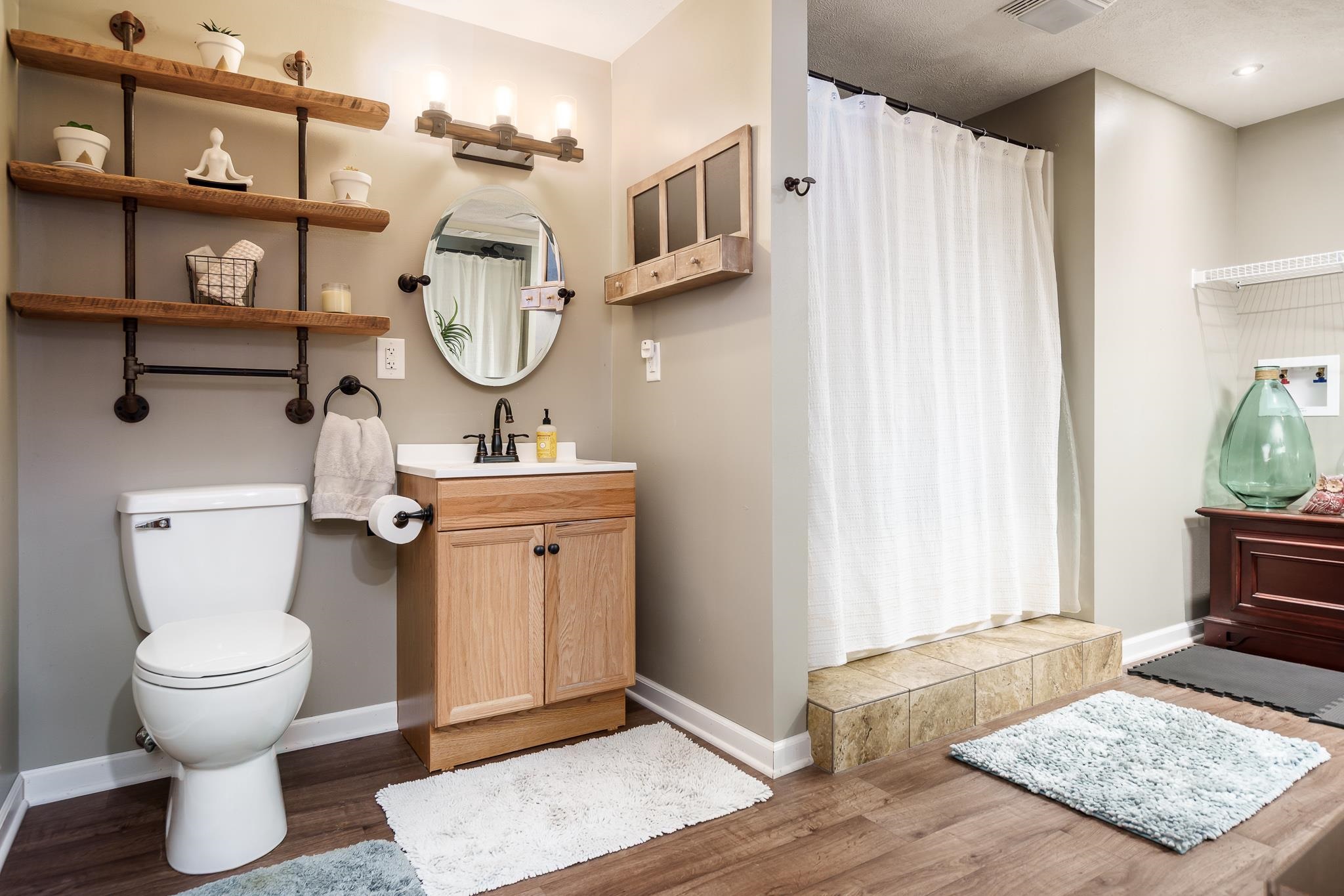 651 Genoa Street Cherry Valley, IL 61016 - Photo 23 of 70 a bathroom with a toilet a sink and a mirror