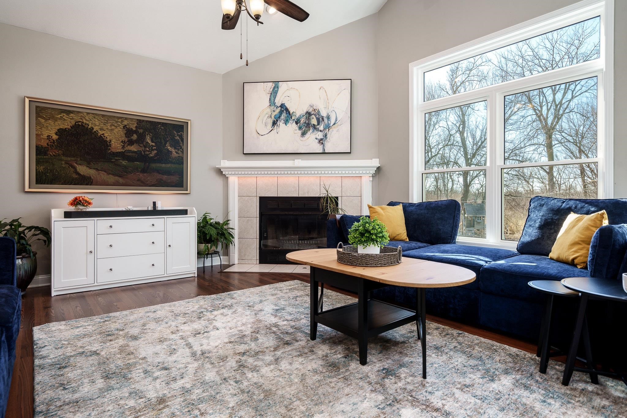 651 Genoa Street Cherry Valley, IL 61016 - Photo 27 of 70 a living room with furniture a fireplace and a flat screen tv