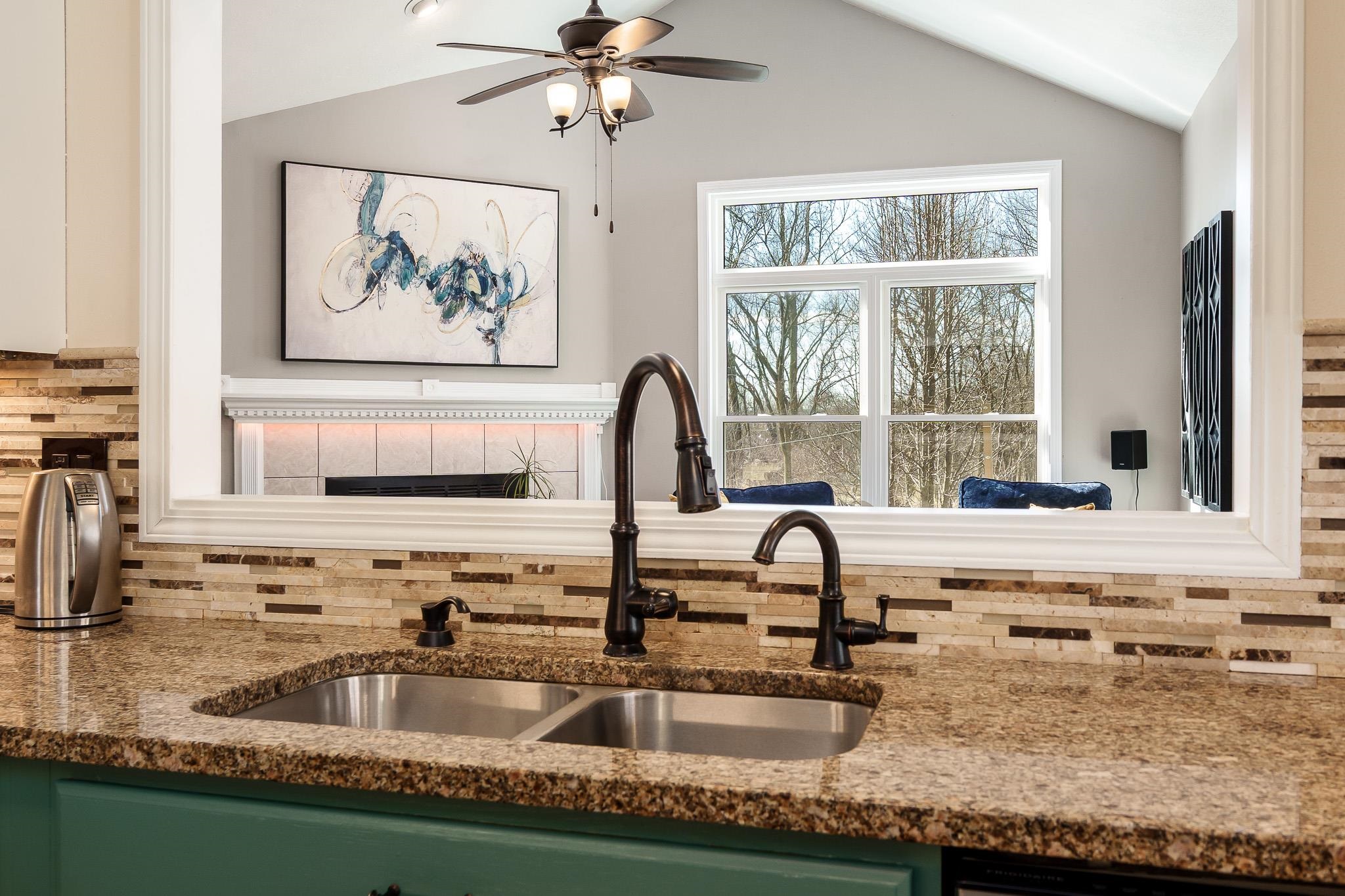 651 Genoa Street Cherry Valley, IL 61016 - Photo 40 of 70 a kitchen with granite countertop a sink and a window